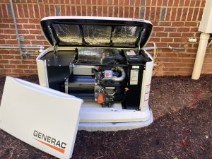 Generac Guardian standby generator open showing internal engine components during residential installation